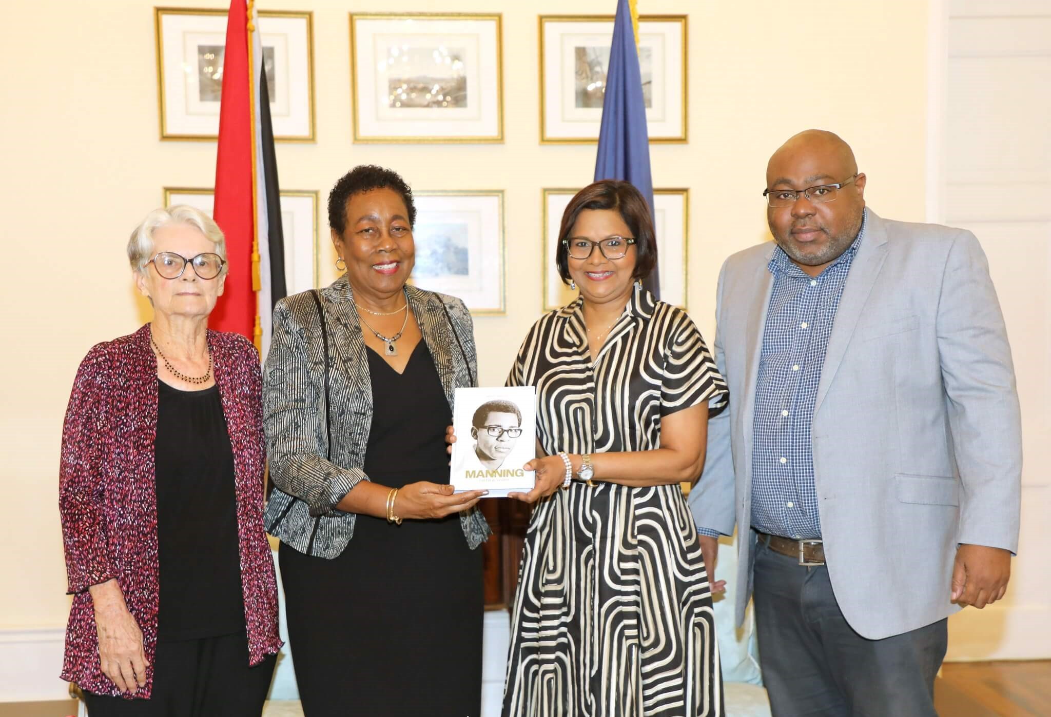 Her Excellency is presented with a Biography of the late Patrick Manning